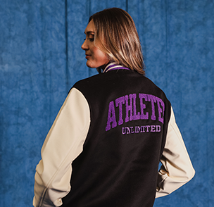 Volleyball athlete Molly McCage wearing an Athletes Unlimited white, purple, and black varsity jacket