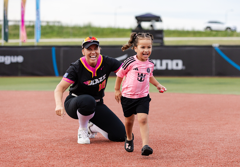 Keilani Ricketts with her daughter on the field during the inaugural Blaze season.