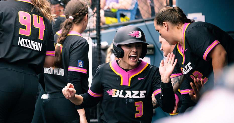 Baylee Klingler high fives teammates in the dugout