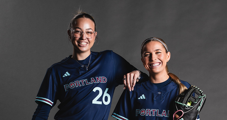 Sam Landry and Sis Bates smiling at camera in dark blue Portland Cascade uniforms